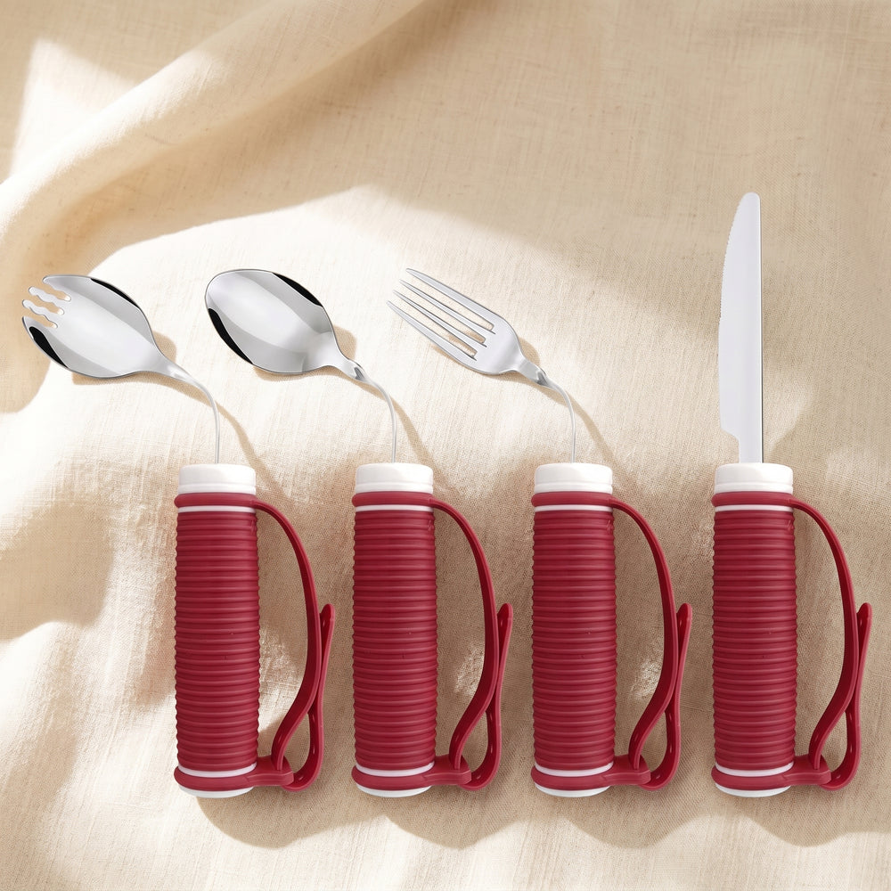 The four-piece Hale & Kin weighted adaptive utensil set — spork, spoon, fork and knife on linen